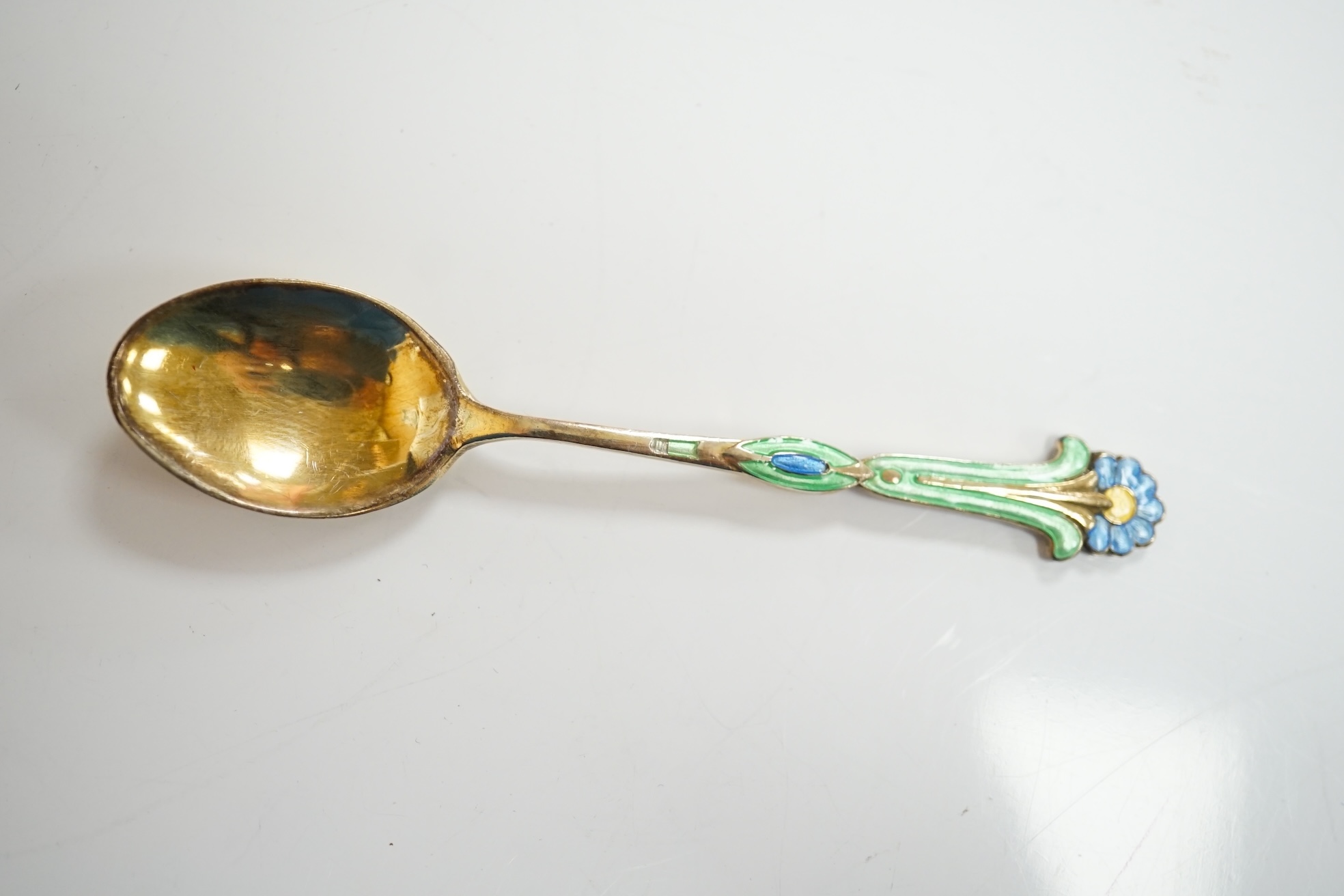 A cased harlequin set of six George VI silver gilt and three colour enamel set coffee spoons, Turner & Simpson, Birmingham, 1940,42 & 48, 89mm, enamel a.f. Condition - poor to fair